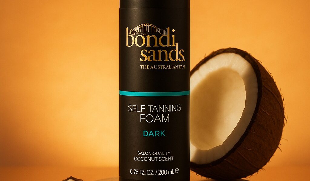 Self tanning foam bottle staged on a reflective sand podium